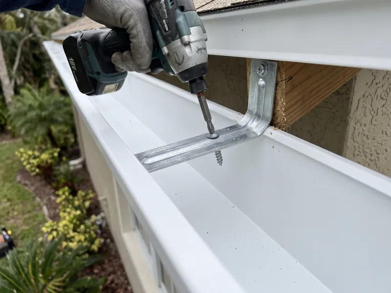 Heavy-duty hidden screw hanger fastened to roof rafter tails in Haines City, FL